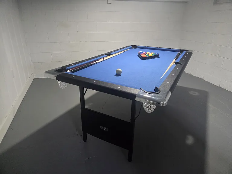 In the downstairs area, try your hand at Pool. The pool table is 6' (not regulation). The room area itself is 132 sqft (12'x11') and is 6'.6" high from floor to ceiling, which is the overall height in the downstairs area.