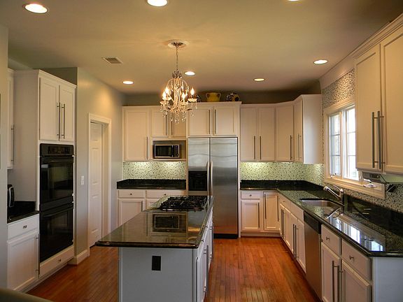 Kitchen with Exotic Volga Blue counters and Custom Glass Backsplash