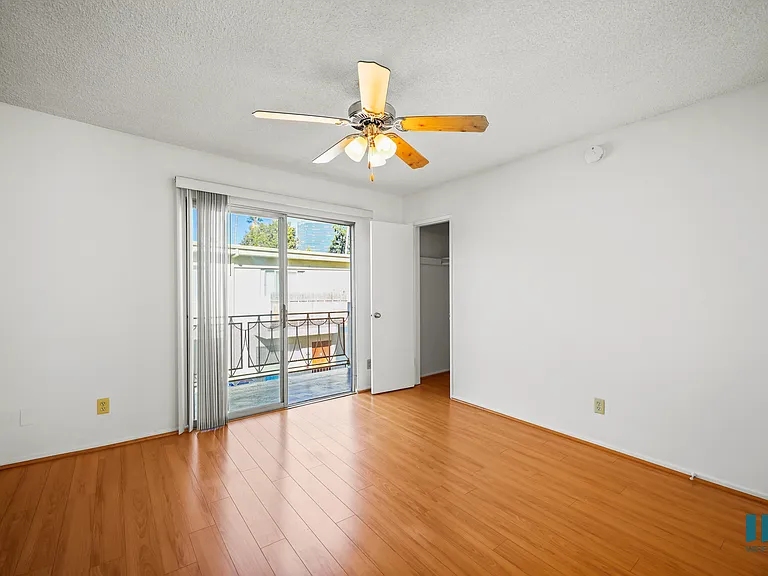 Bedroom with Vinyl Flooring, Ceiling Fan, Closet, and Balcony