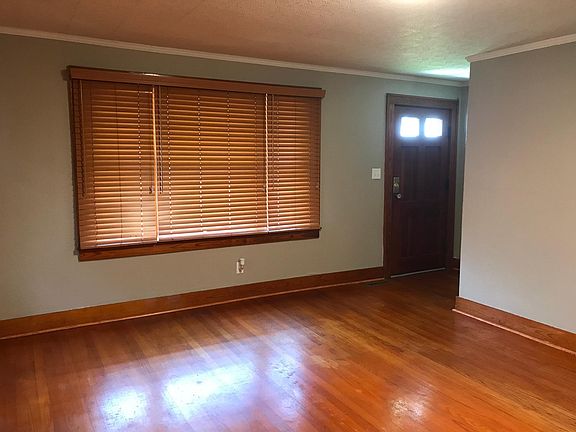 Living room. Custom blinds throughout the home.