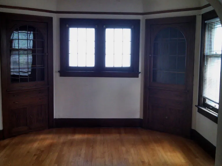 Hardwood floors and built-in corner china cabinets