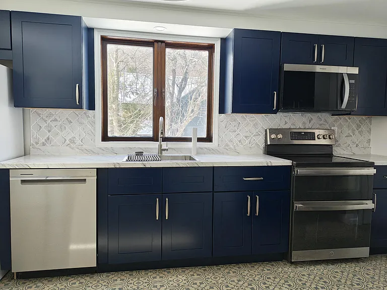 Kitchen with electric range, microwave, and dishwasher