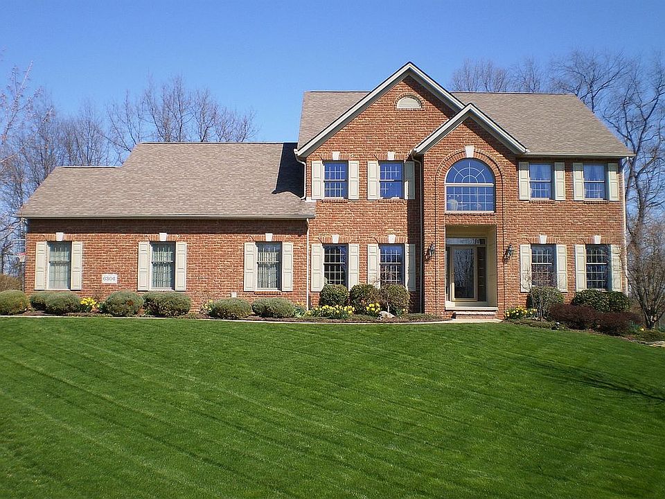 House sits above street level on large lot