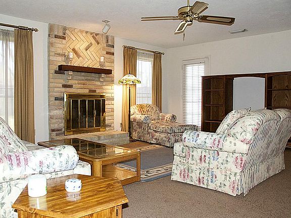 Family room with wood burning fireplace.