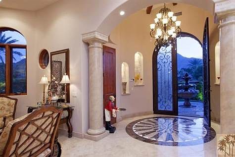 The foyer has light niches on both sides to showcase your art collectibles.  The custom  stone medallion is inlaid in Travertine and assembled one piece at a time.