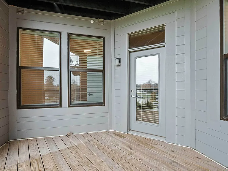 Your two-bedroom Flat 203 apartment features an expansive balcony with durable wood decking and modern railing _ ideal for indoor-outdoor living in Columbus. Your two-bedroom Flat 203 apartment features an expansive balcony with durable wood decking and m