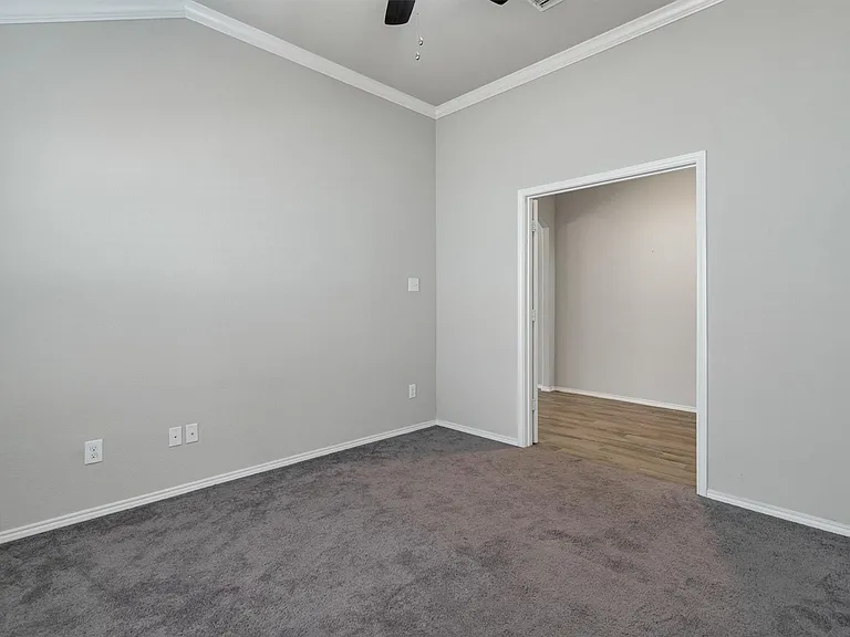 Spacious room with vaulted ceilings and crown molding