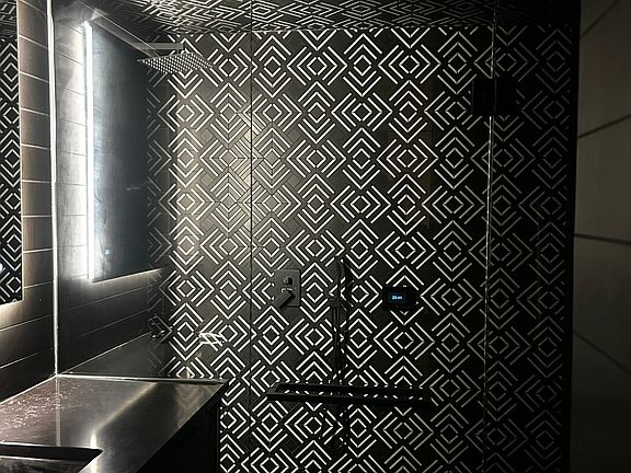 Spacious, modern bathroom featuring a luxurious walk-in steamer shower for a spa-like experience.