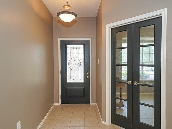Beautiful glass leaded front door as well as a  glass French door to the study with updated light fixture !