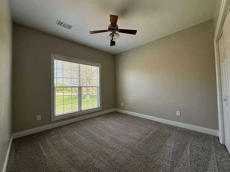 3rd bedroom with large window overlooking the right side of the home. Has a large closet