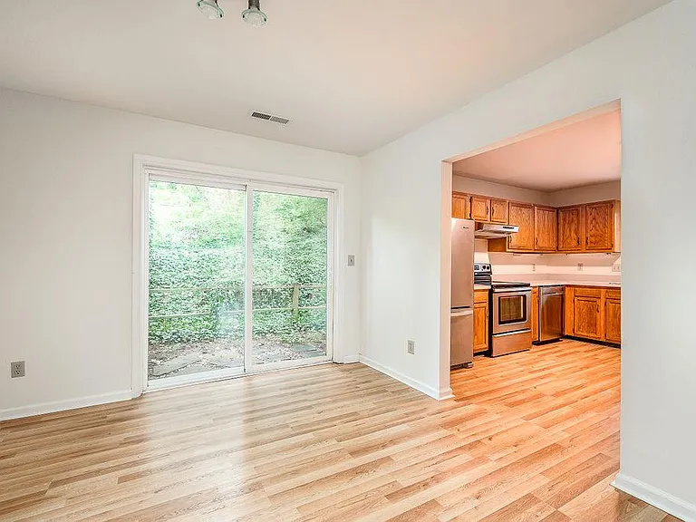 Dining room with sliding doors opening into a small fenced area outside
