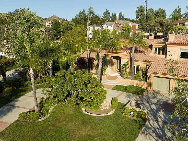 Lush "California Dreamin" landscaping as you come up the circular drive.