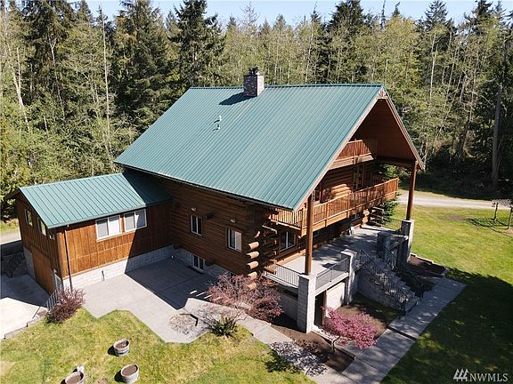 Shot from above showing large garage/shop and beautiful patio for entertaining