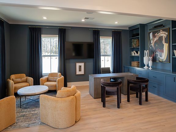 Clubhouse interior with leasing desk and relaxing sitting area.