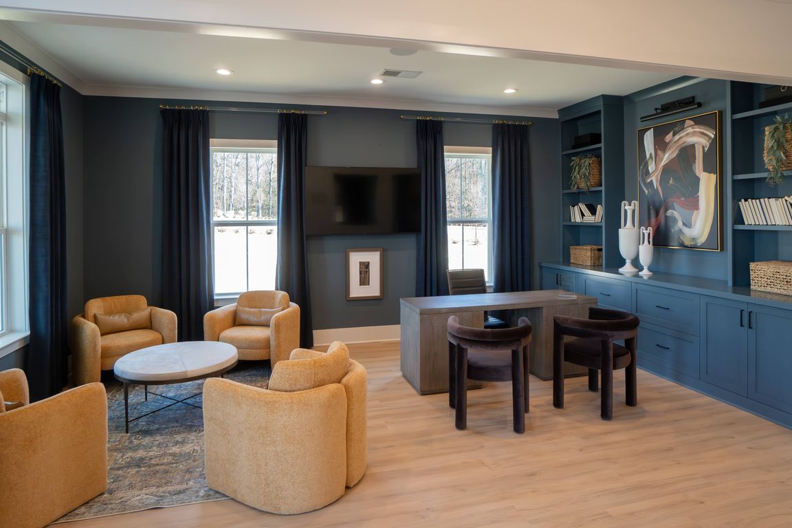Clubhouse interior with leasing desk and relaxing sitting area.
