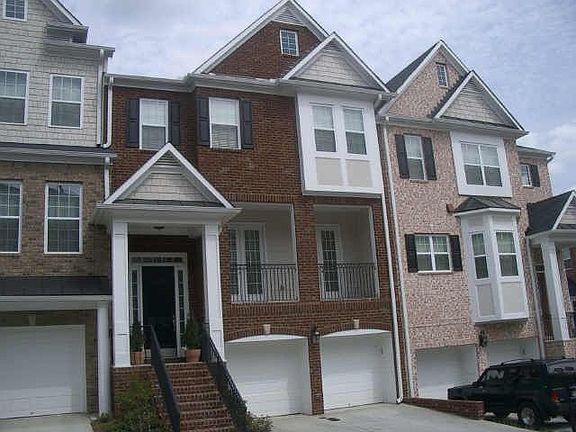 Beautiful brick townhome with wooded ravine view on back three levels