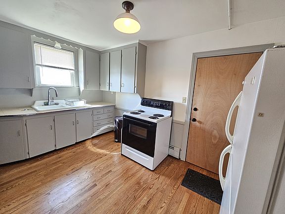 Kitchen with electric stove and refrigerator