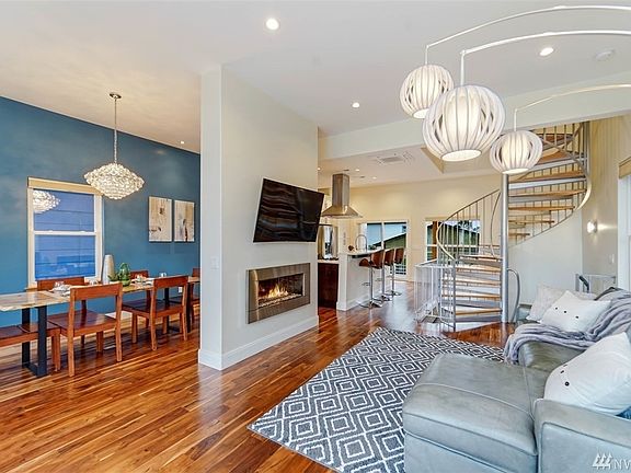 Modern Greenlake smart home with rooftop deck, Lake and Mt. Rainier views, cedar siding, metal roof, and modern and vibrant colors. Steps to Green Lake in a prime location!