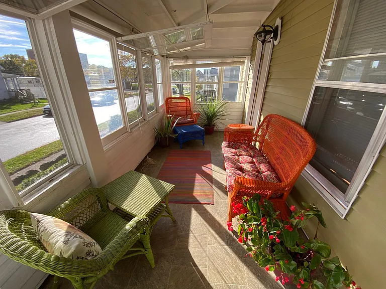 The front door is accessible through the cozy sunporch.