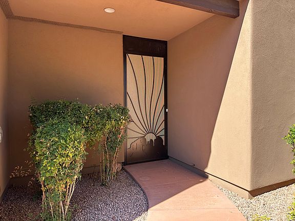 Front entry area with screened/Security Door. Area behind leads to the front door.