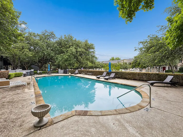 Resort-style pool featuring stone coping and a concrete surround