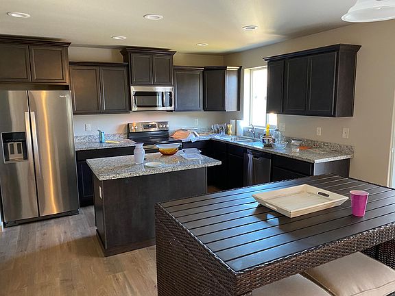 Kitchen with island. wicker furniture does not stay.