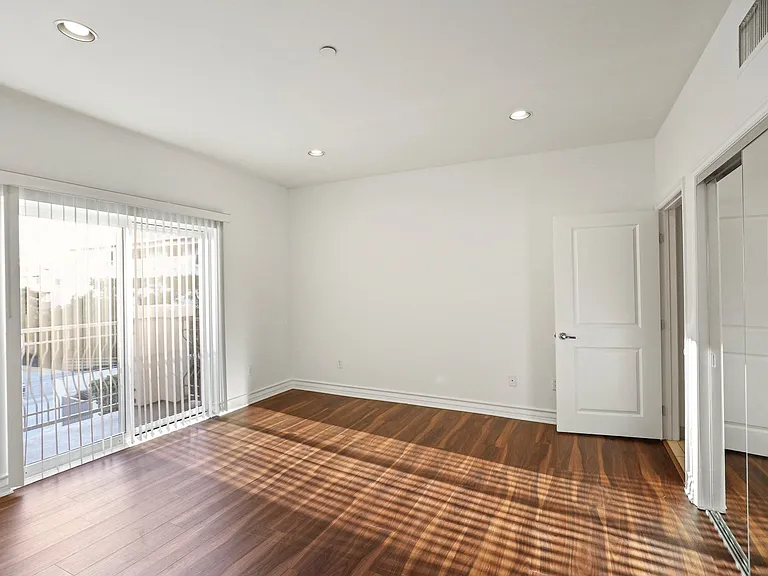 Bedroom with Closet, Balcony, and Vinyl Flooring