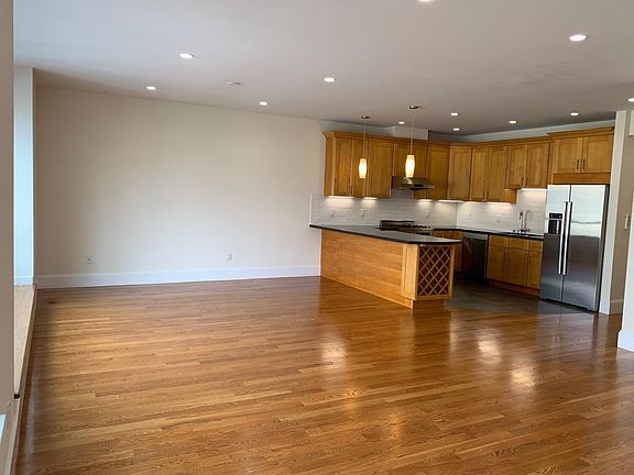 Upstairs open great room and kitchen with all stainless steel appliances and wine storage.
