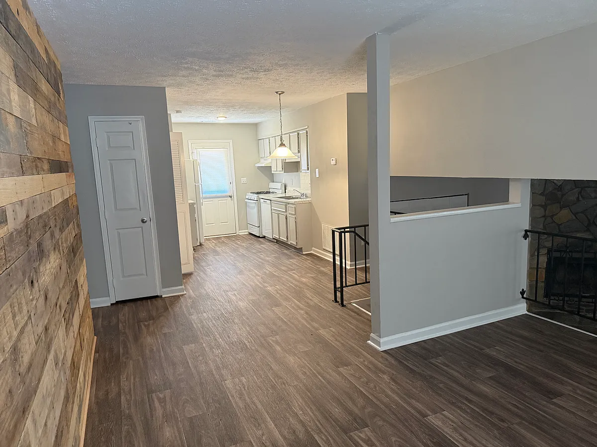Front entrance view of family room that has been fully remodeled with new flooring and fresh paint throughout. - 1202 Natchez Trce #A