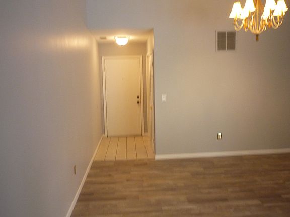View back to the entry door. Ceramic tile at the entry. Luxury vinyl in the great room.