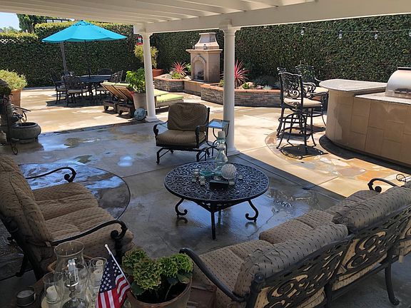 Covered patio and large outdoor space with gas fireplace and built in gas BBQ with refrigerator.