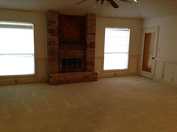Den features fire place, ceiling fan and carpets have been nicely cleaned.