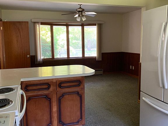 Partial view from kitchen to dining area. Large refrigerator included.