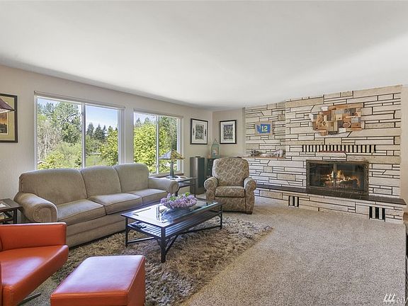 The spacious living room features a gorgeous Arizona Sandstone fireplace surround and a Heatilator fireplace insert.