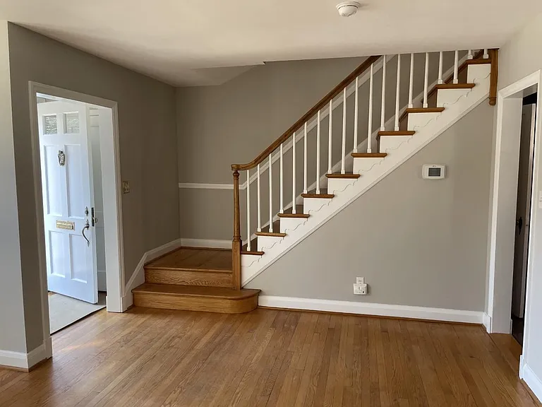 Foyer with Coat Closet and Living Room Stairs