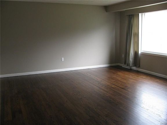 Generous size living area with Beautiful Hardwoods and a Large Window overlooking the Front Yard.