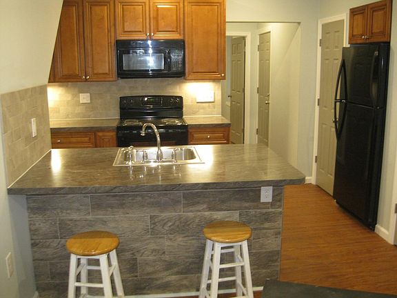 Kitchen has a pantry next to the full fridge