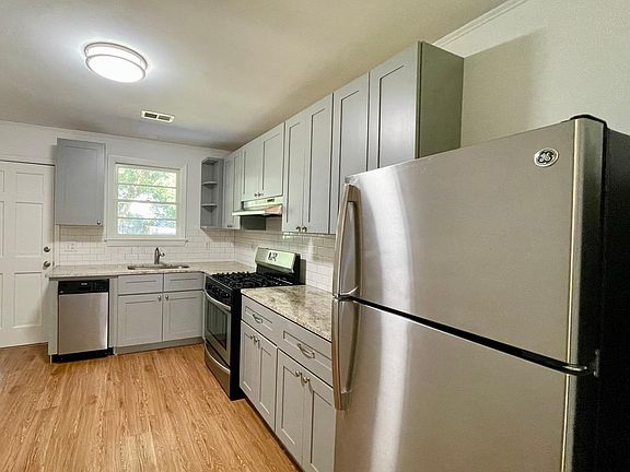 Large eat-in kitchen (partial view) equipped with gas range, dishwasher, and refrigerator.