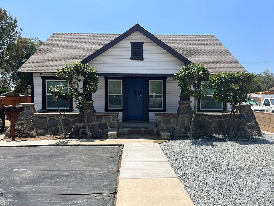 Beautiful rock front porch from 1927. Water wise front yard.