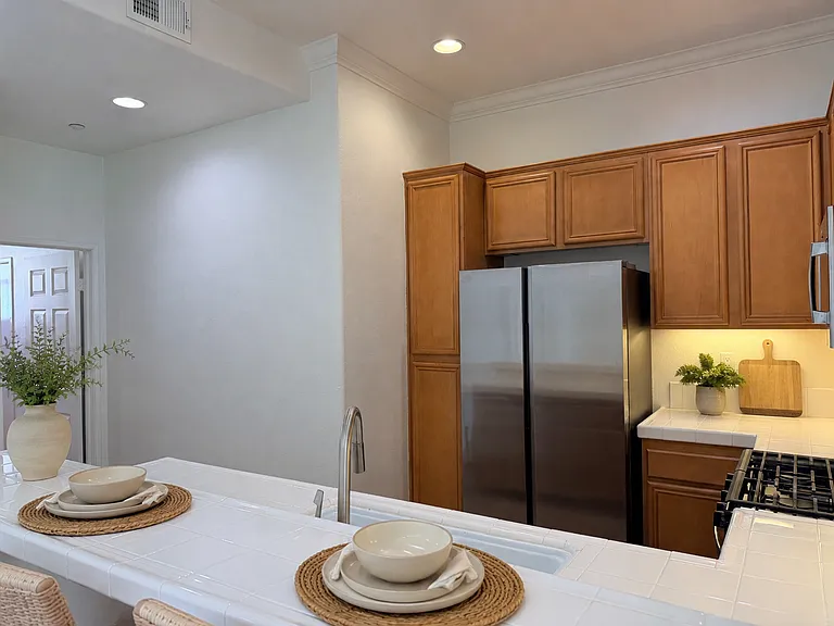 Kitchen Virtually stages. Left door leads to laundry room