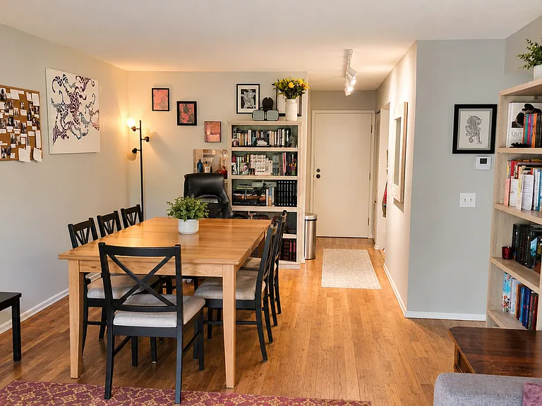 Dining room with track lighting and hardwood floors.