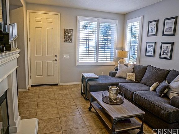Nice flooring, shutters and gorgeous mantle in this living room