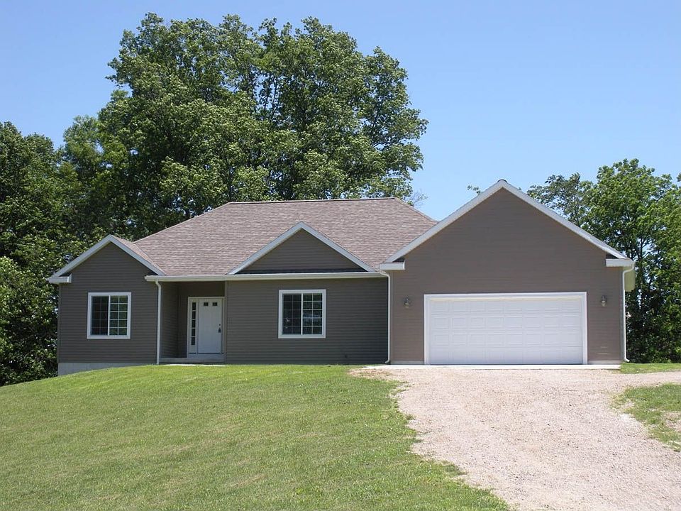 This view of the hipped roof line from behind a walnut tree welcomes you home 
