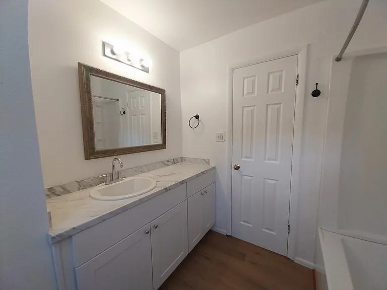 Large vanity and mirror in main hall bath