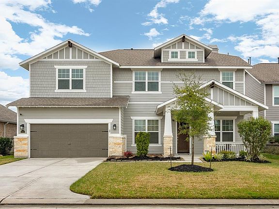 Craftsman details on the exterior highlight this beautiful lightly lived in home