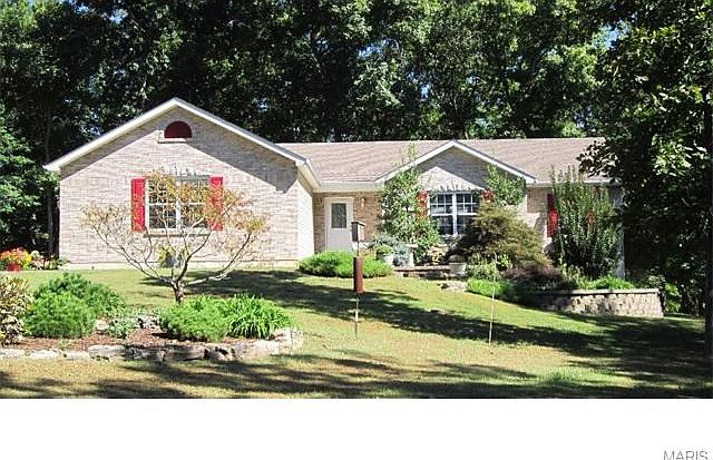 Front of home with side entry garage.