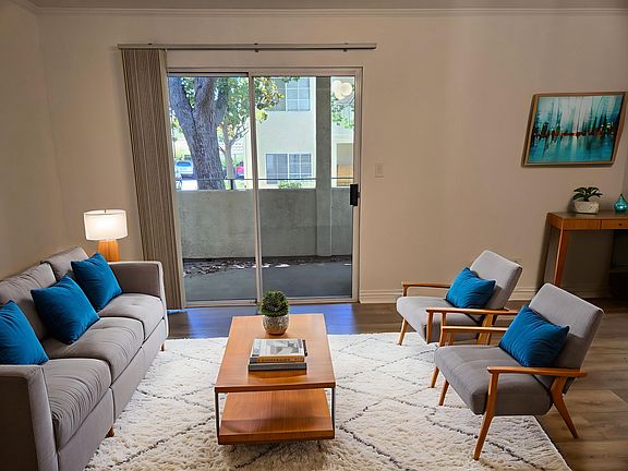 Livingroom (in another angle) showing the patio is virtually staged