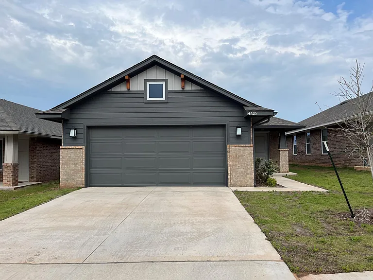 Charming curb appeal with a beautifully maintained facade, featuring a welcoming entry door with a sidelight window, a clean walkway, and a spacious 2-car garage. The front of the home offers a warm first impression with tasteful design and natural light