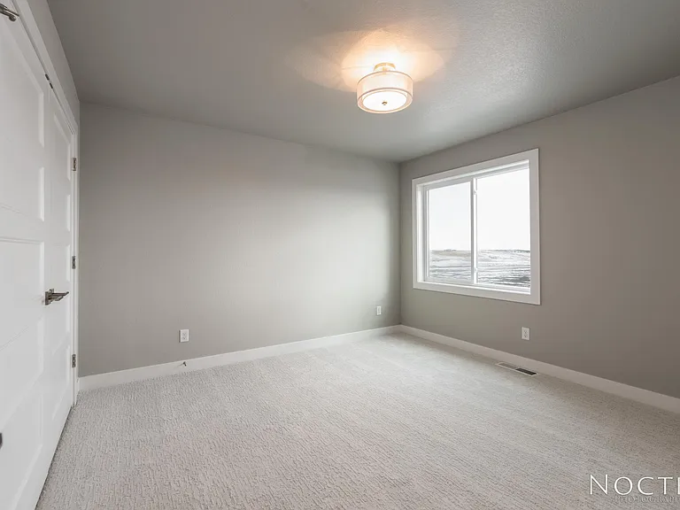 One of two extra bedrooms upstairs. (Photo of another unit with similar finishes and quality.)