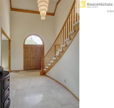 Soaring entry way boast double front doors